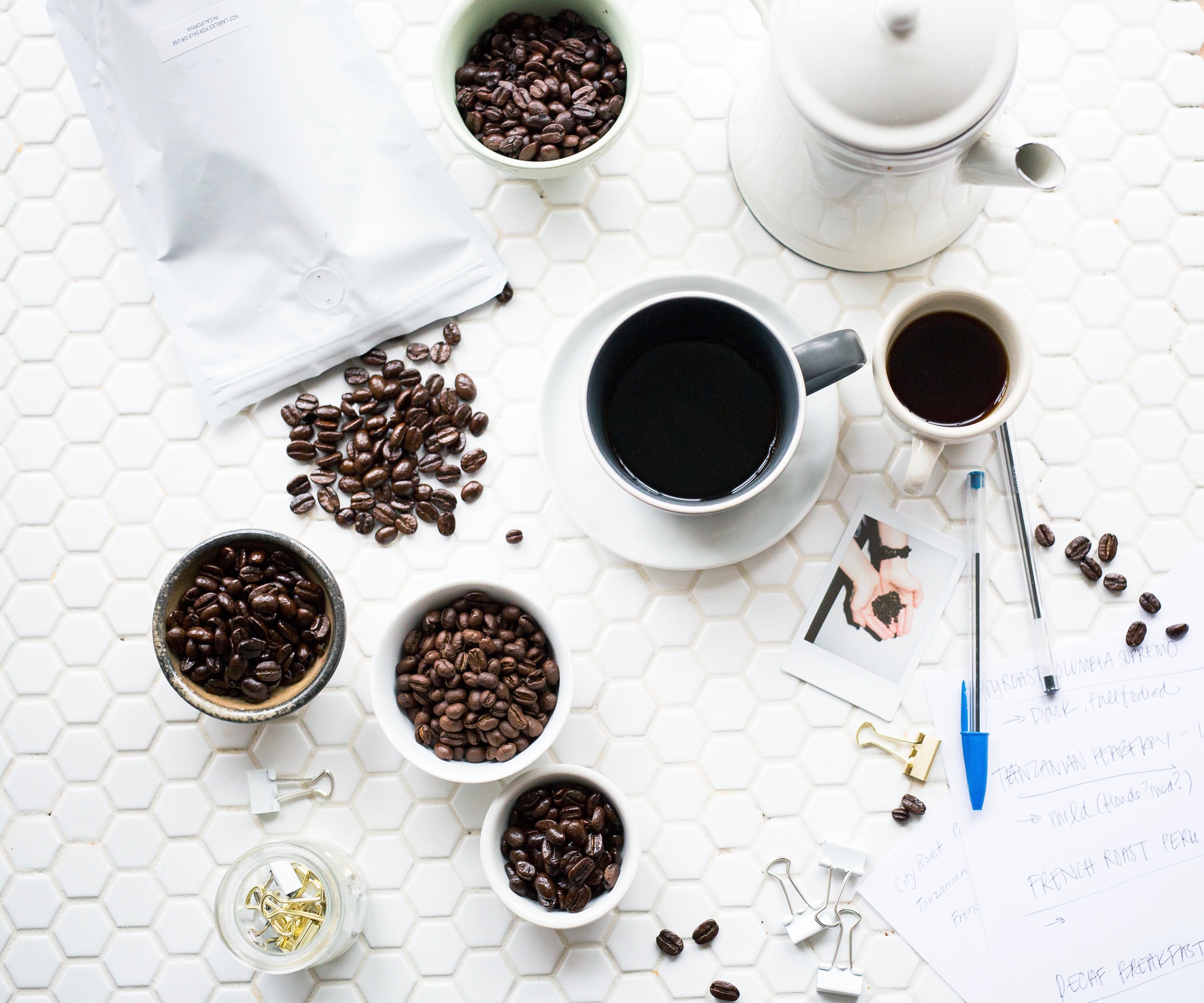 Coffee beans and cups on a white background